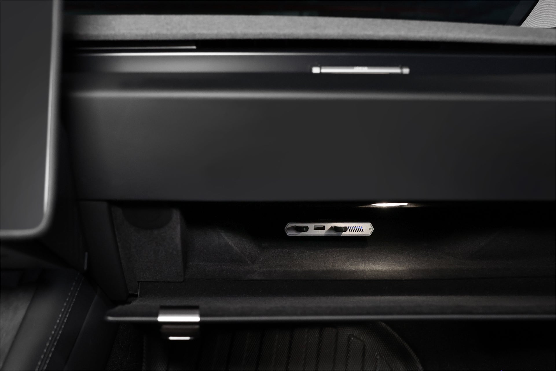 The interior of a Tesla Model S's open glove compartment features a JOWUA 3-Port USB DashCam Hub with a 1TB NVMe SSD. The illuminated space highlights the SuperSpeed+ high-efficiency storage capabilities, sleek design, and smooth textures of the dashboard.