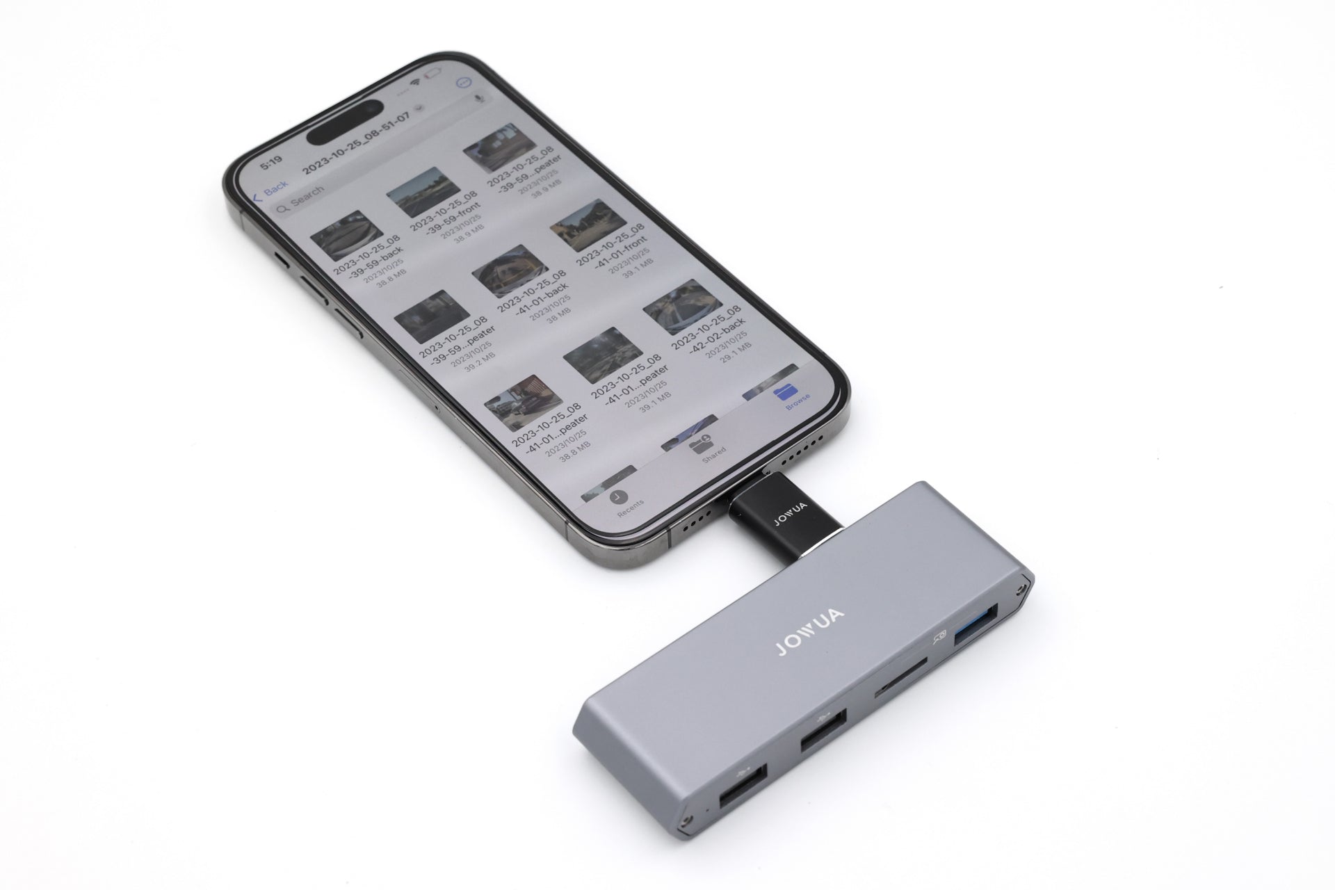 A smartphone is connected to the JOWUA 3-Port USB DashCam Hub (MicroSD Reader) V2, an ideal accessory for Tesla owners. The phone's screen shows a file manager app with various file icons. This hub enables USB expansion with multiple ports and is displayed against a white background, ensuring seamless connection without electromagnetic interference.