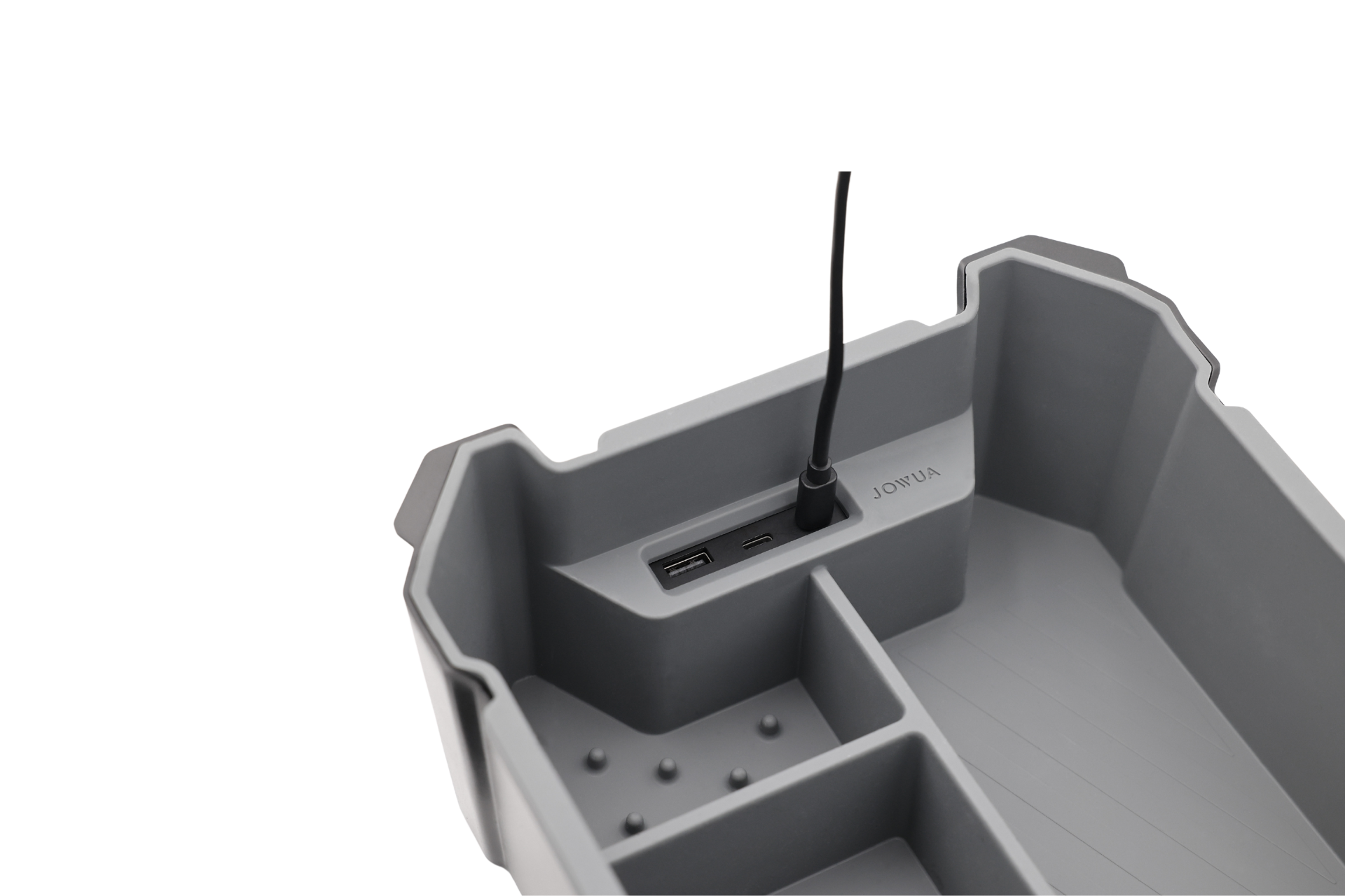 The gray multi-compartment organizer from JOWUA, designed for the Tesla Cybertruck, is crafted from premium silicone and includes a built-in charging station. A black cable is plugged into one USB port. "JOYJUL" marks are near the ports, with multiple sections for organizing items.