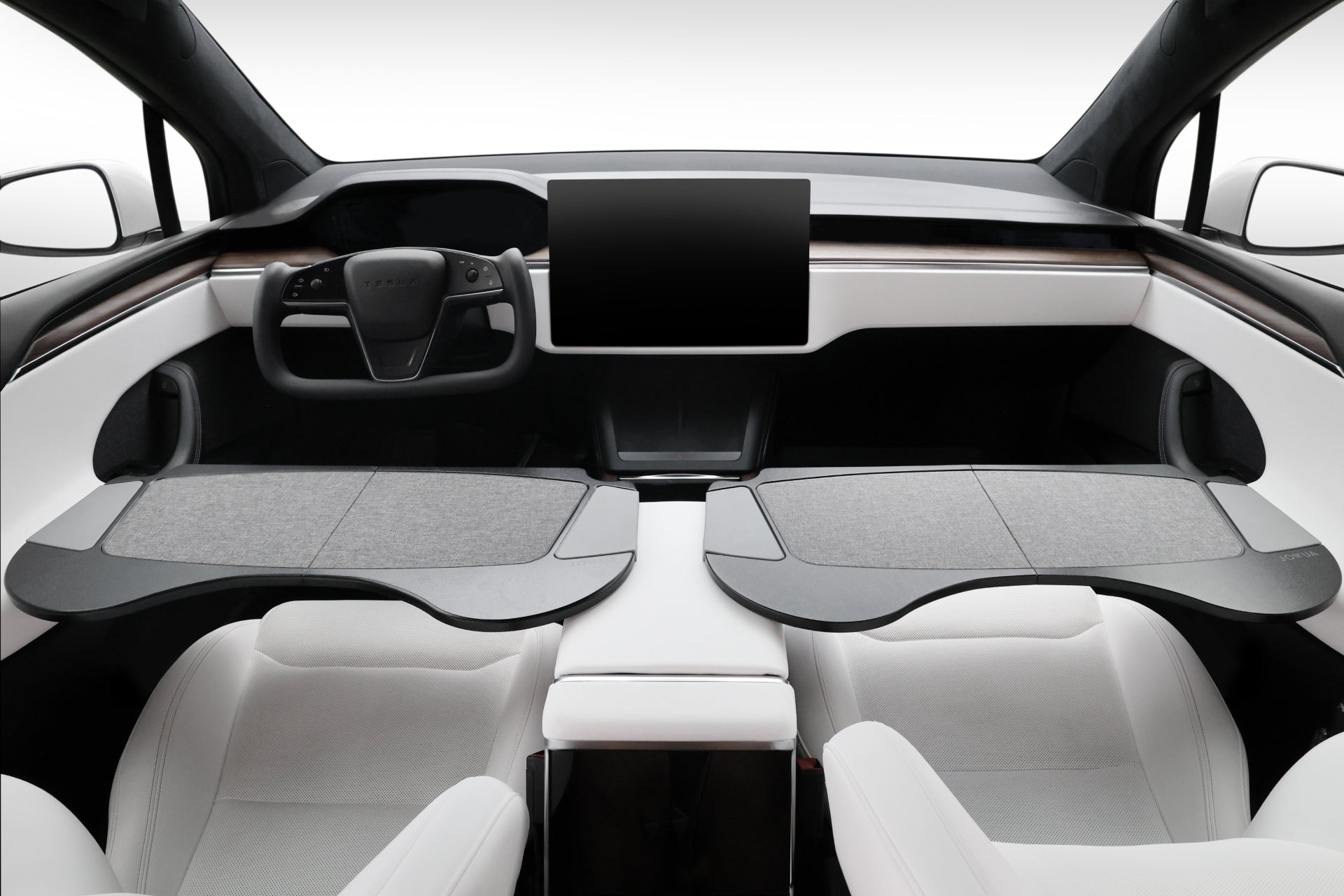 The interior of the futuristic car features two seats, a large touchscreen display, and a yoke-style steering wheel. Premium materials enhance the sleek and minimalist design, while the JOWUA Foldable Car Tray for Tesla adds an extra layer of convenience.