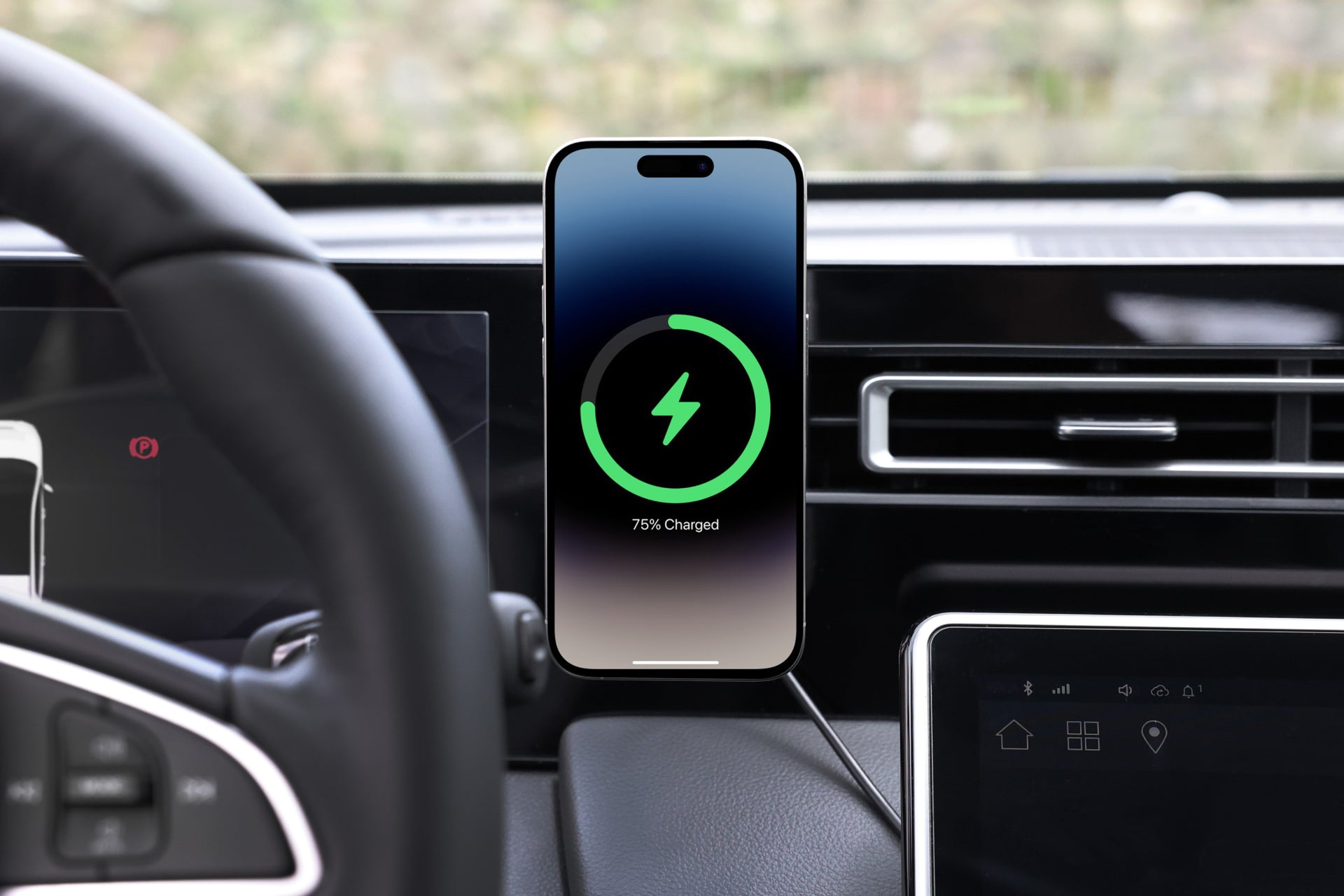 A smartphone showing a green charging icon with "75% Charged" is mounted on the dashboard using the JOWUA Universal MagSafe Car Mount for Air Vents, utilizing 15W Fast Charging. The steering wheel and interior controls are visible in the foreground, highlighting an efficient and seamless drive.