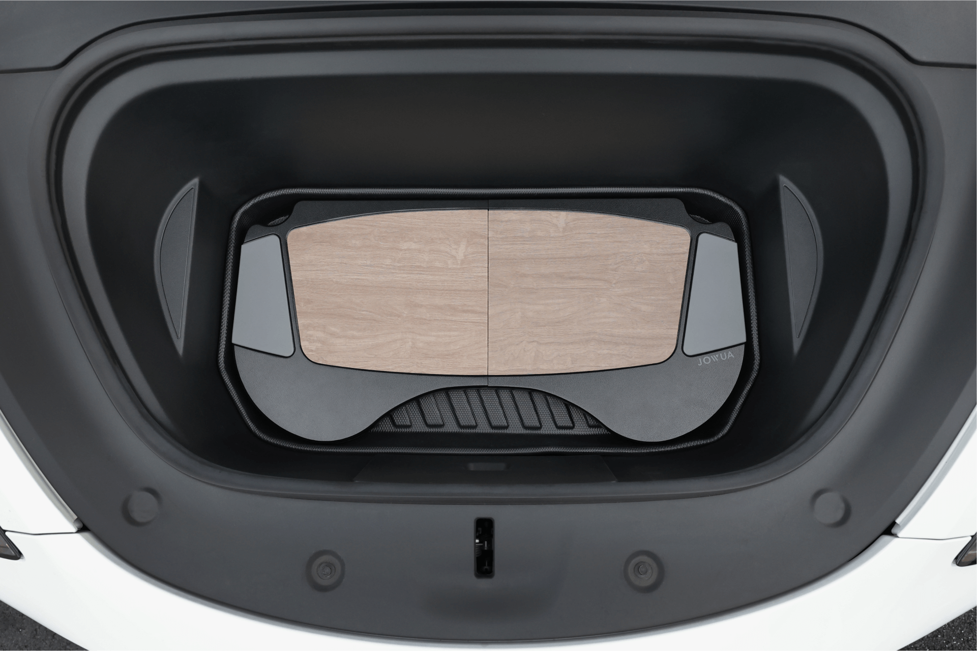 The image features the trunk of a white electric vehicle, showcasing a storage compartment lined with a wooden mat and black trim, enhanced by PU leather accessories for an elegant touch. Displayed is the Foldable Car Tray for Tesla by JOWUA.